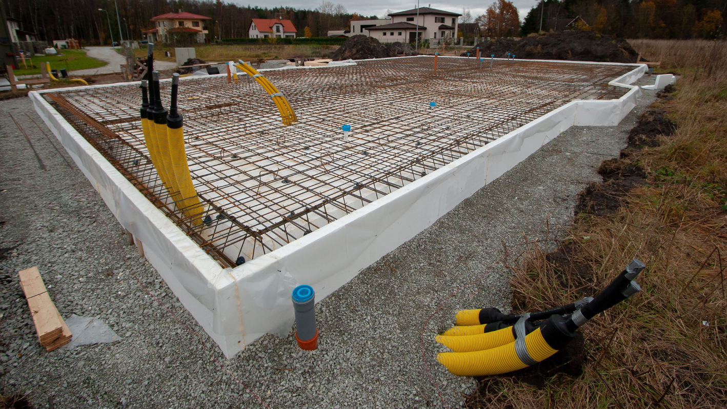 A building under construction with a bunch of tools on the ground